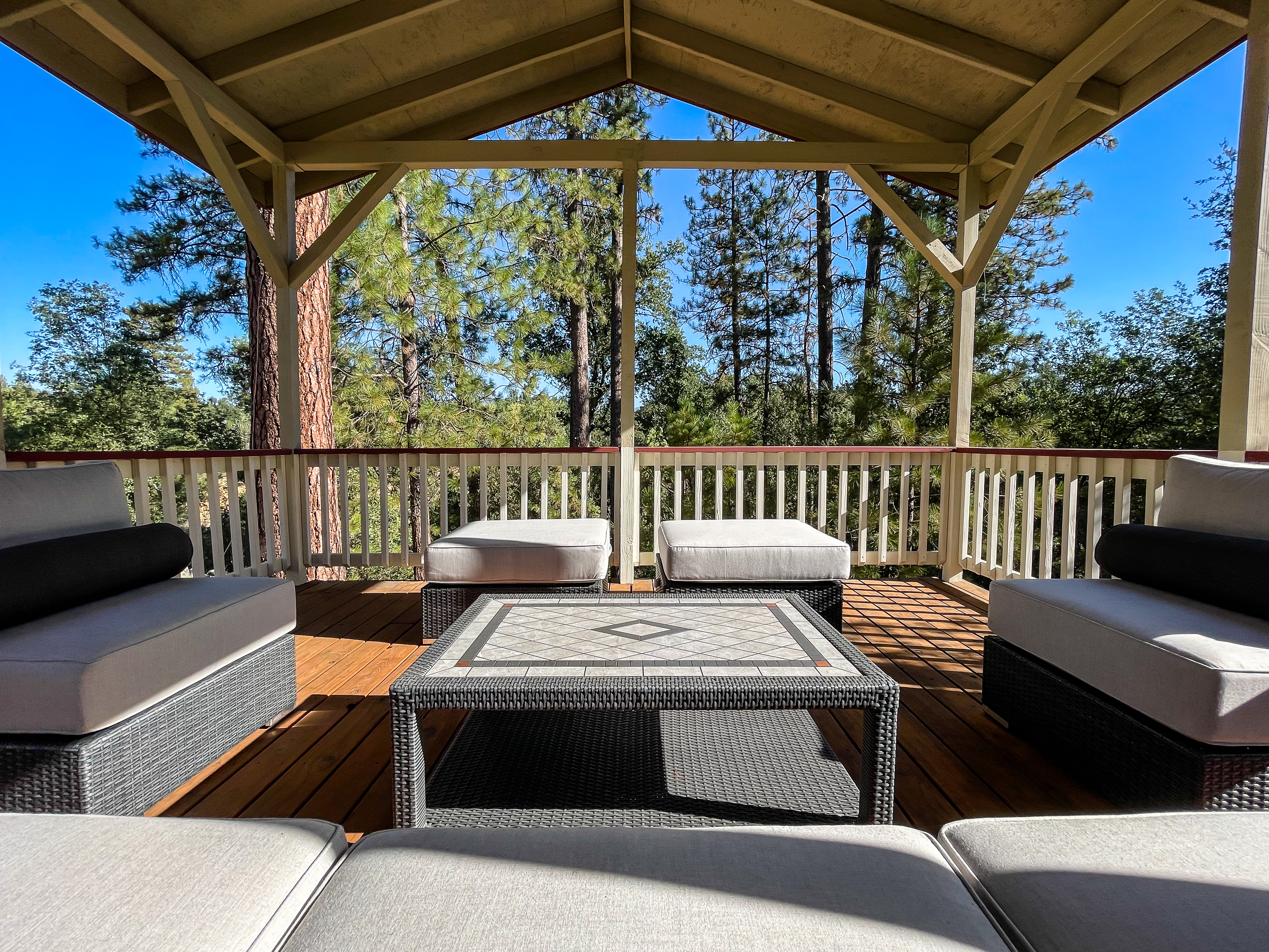 Deck seating with expansive forest views.
