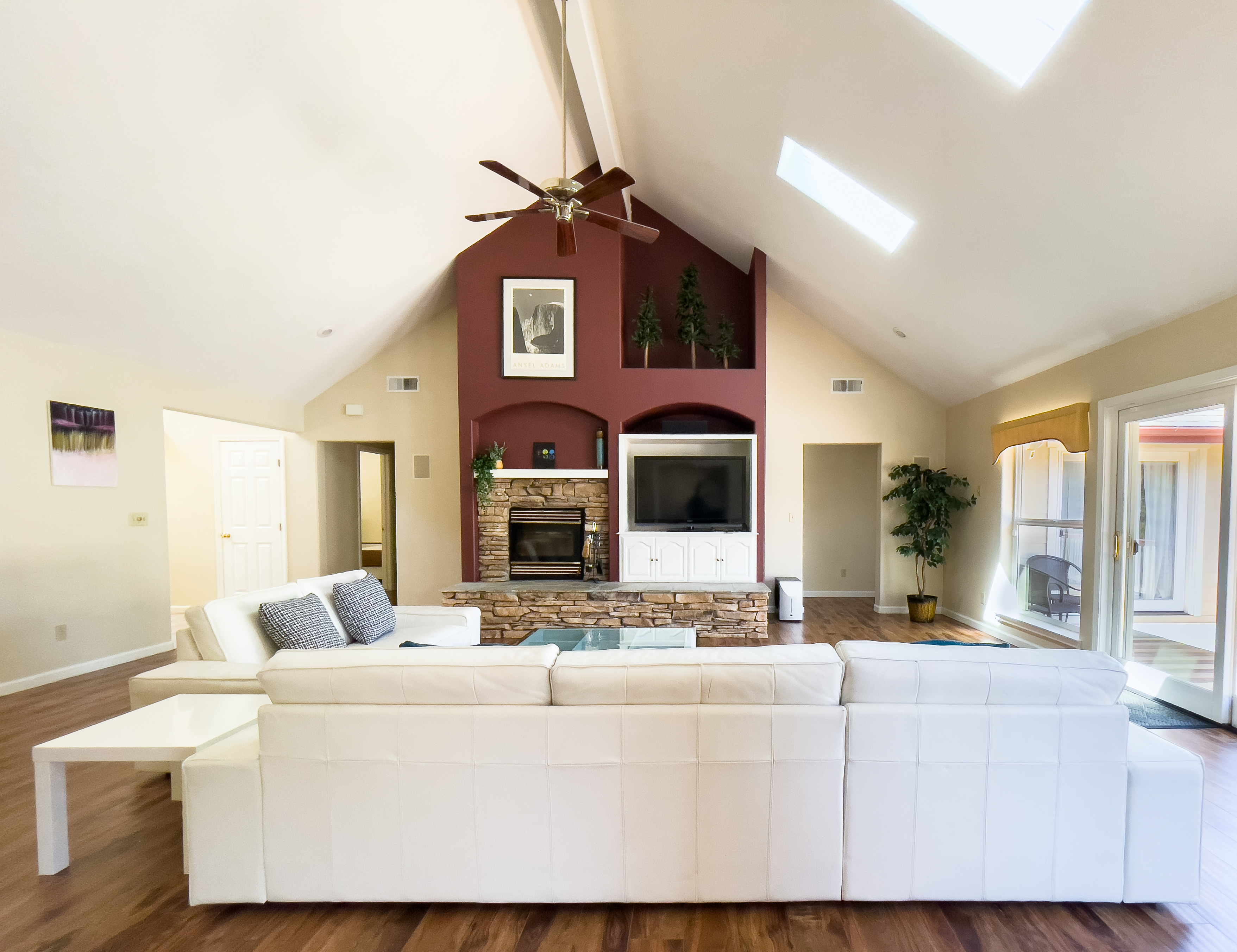 Greatroom with sofa, surround sound system, and TV for family time.